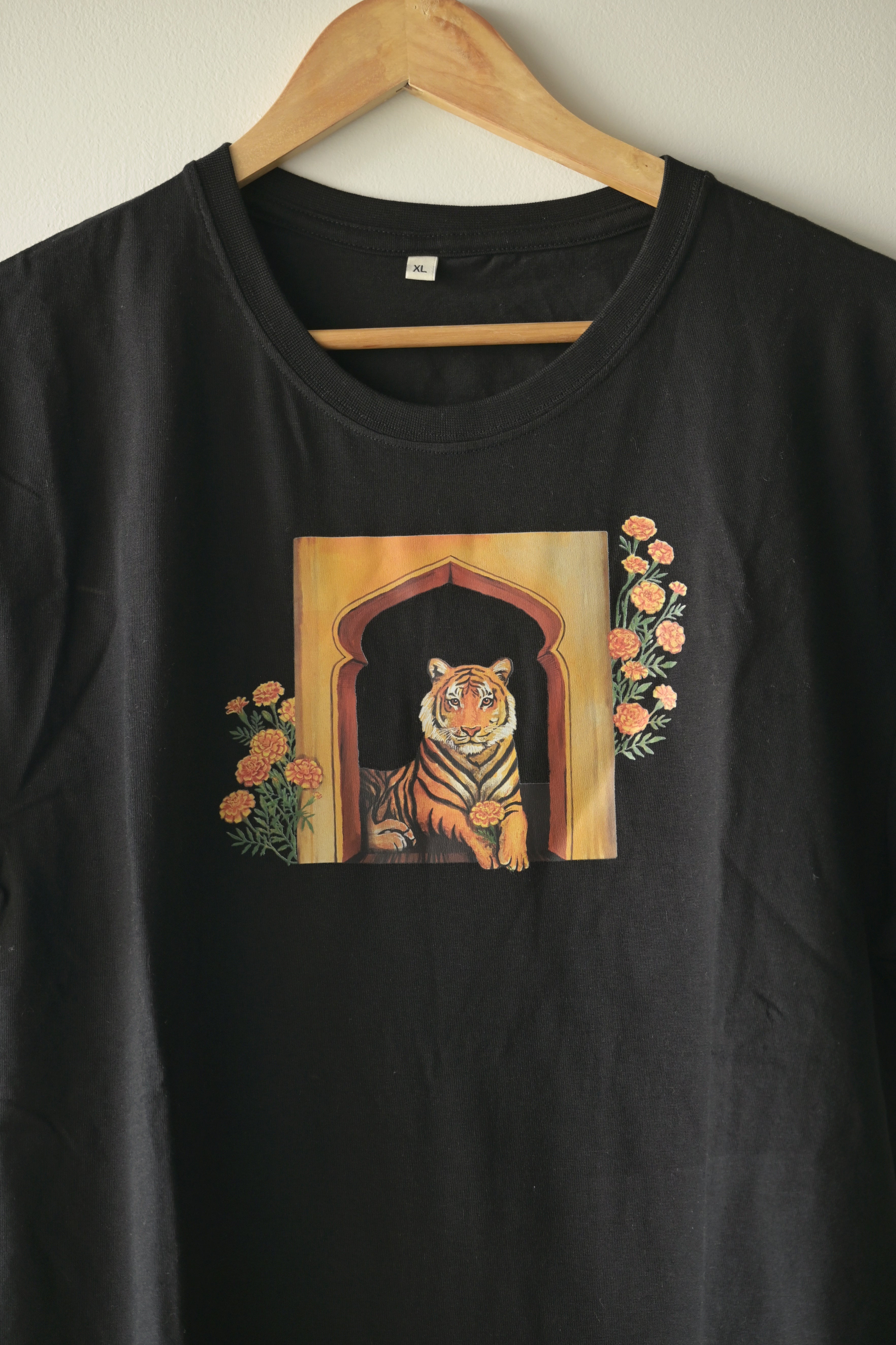 A tiger holds the marigold flower gently 🌼