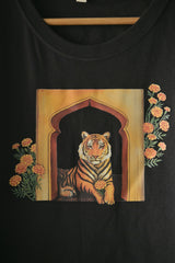 A tiger holds the marigold flower gently 🌼